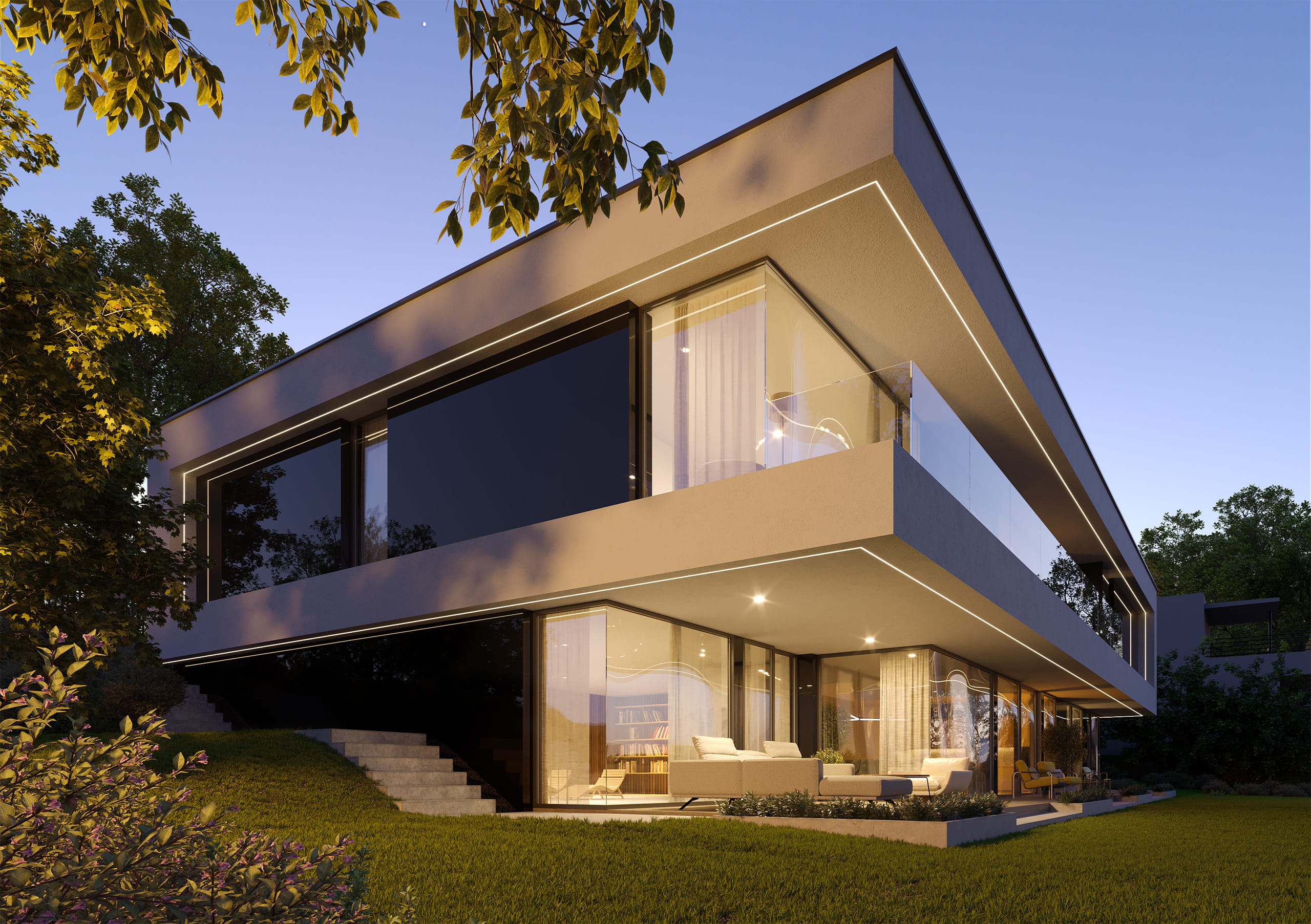 Večerní pohled na vilu, kde se zahrada stává součástí architektury a skrze prosklení vstupuje do interiéru.